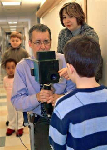 Dr. Hunter scans a child with a prototype vision screener