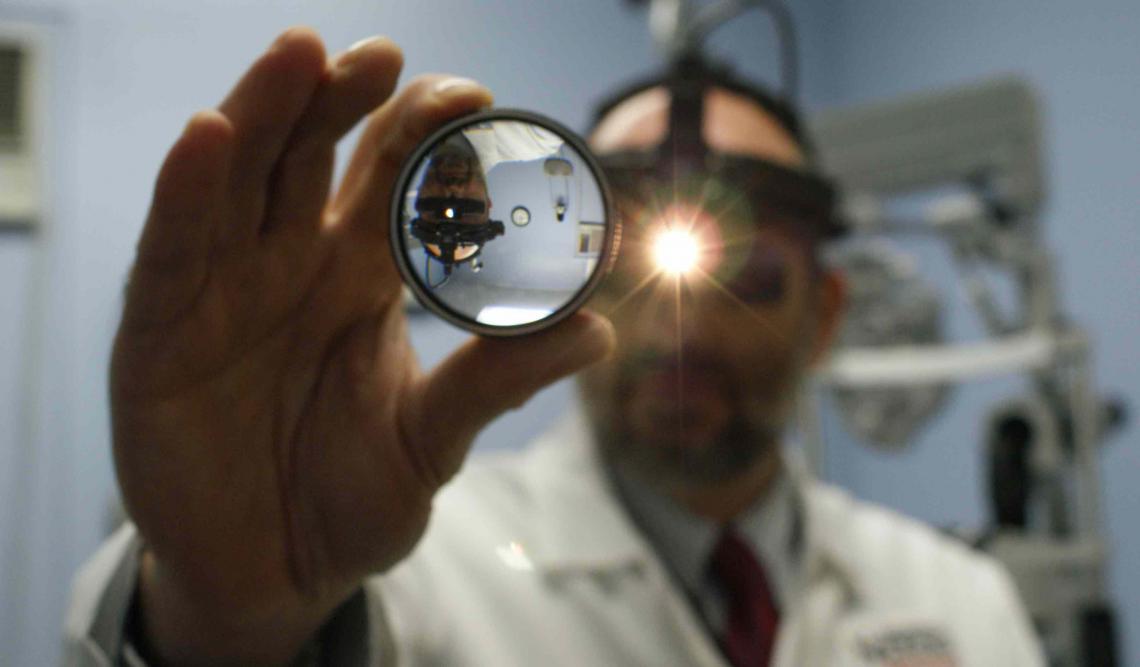 Vision doctor holding an examination device