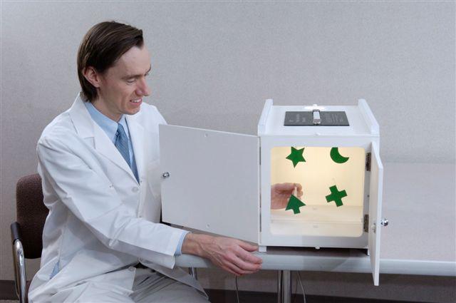 Doctor with vision screening equipment