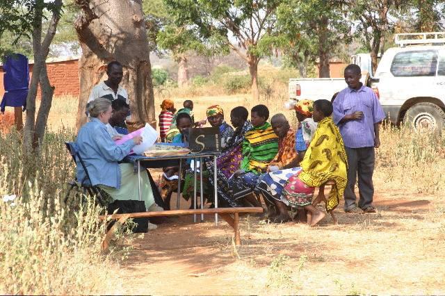 Dr. Sheila K. West meets with patients at a table outside